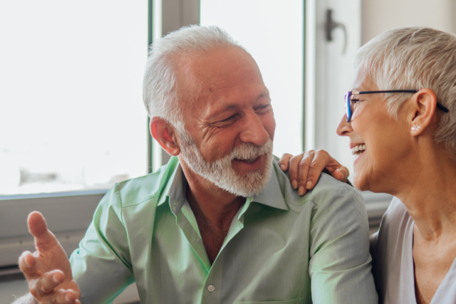 older couple laughing and looking at each other